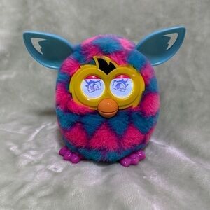 Hasbro Furby Boom interactive toy with a pink and blue hearts pattern.